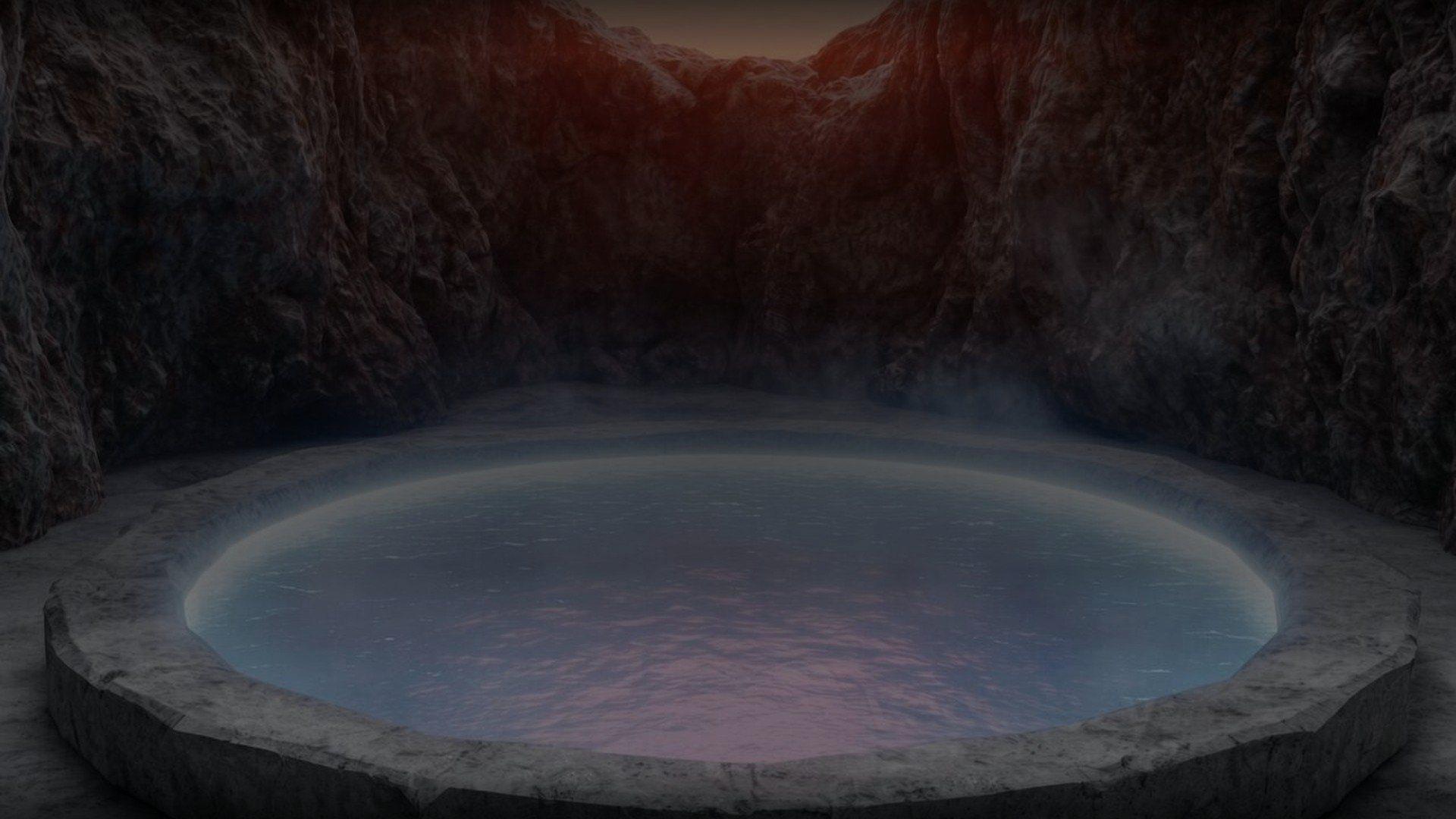 A round mineral hot spring rockpool steaming in a granite grotto at dusk, one of the villa rockpools at Om